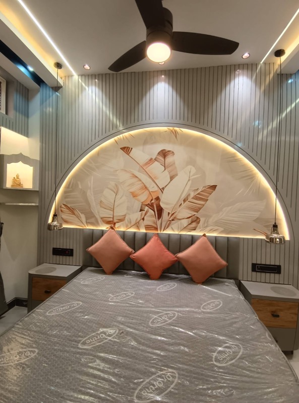 Bedroom feature wall with arched headboard and ceiling fan