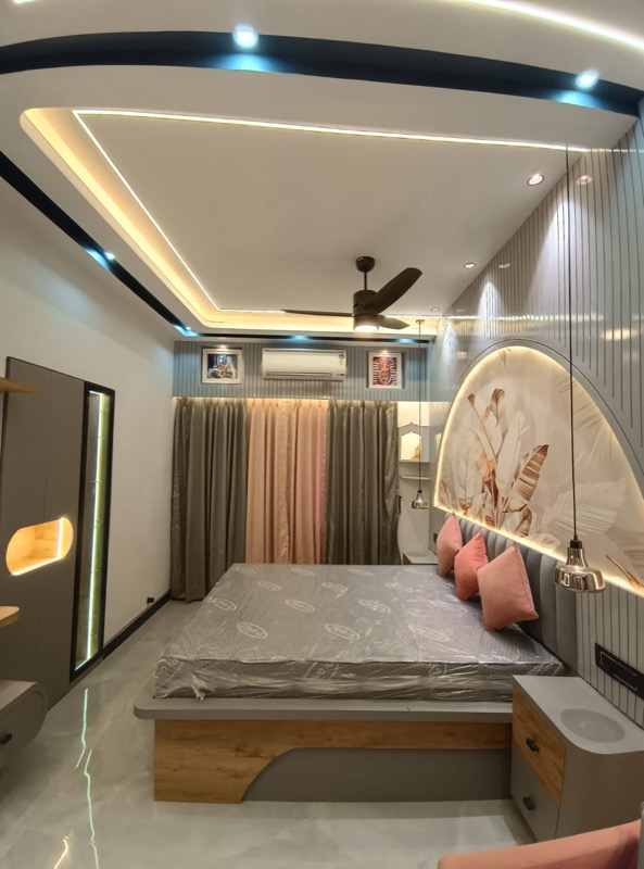 Bedroom with layered ceiling light and custom headboard