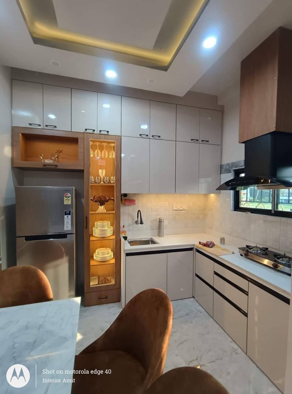 Modern modular kitchen with gloss cabinets and dining edge
