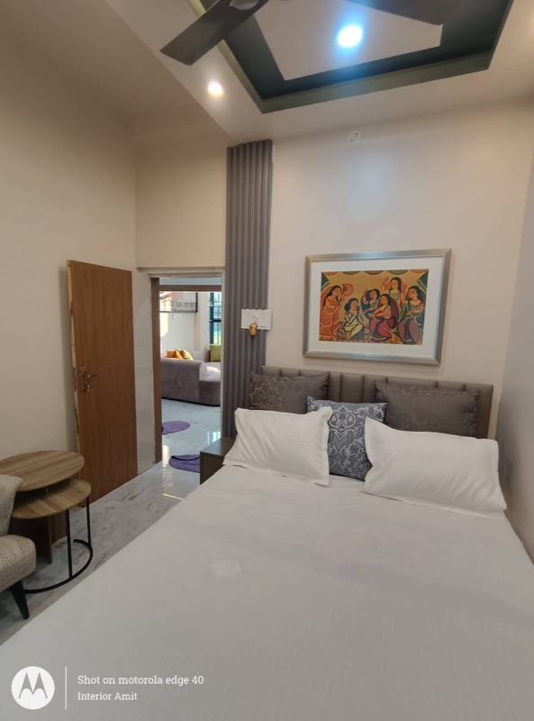 Guest bedroom with framed art and compact side table