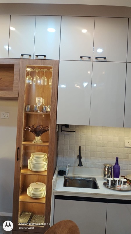 Crockery and kitchen storage with gloss finish and display shelves